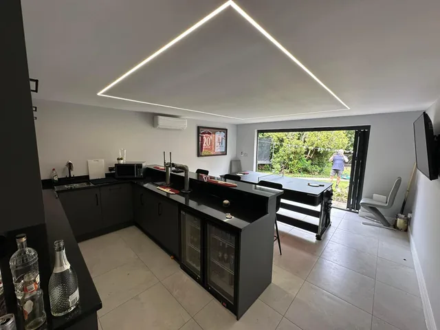 Geometric recessed lighting above a kitchen island